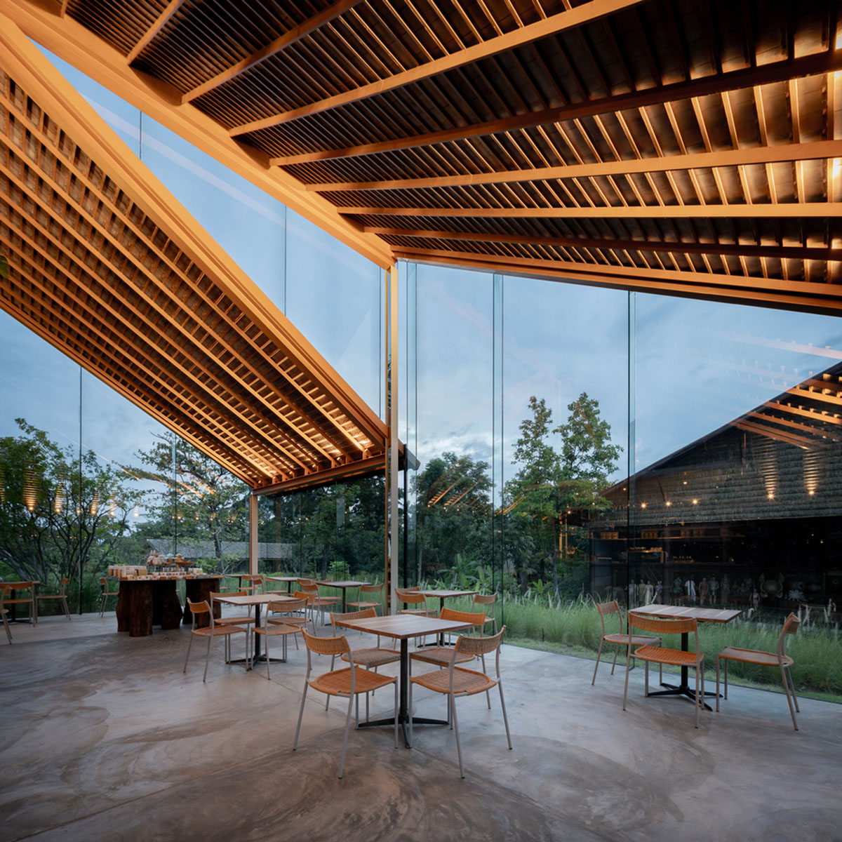 NITAPROW designed Patom Cafe with four segmented roof and thatched-roof walkway in Thailand