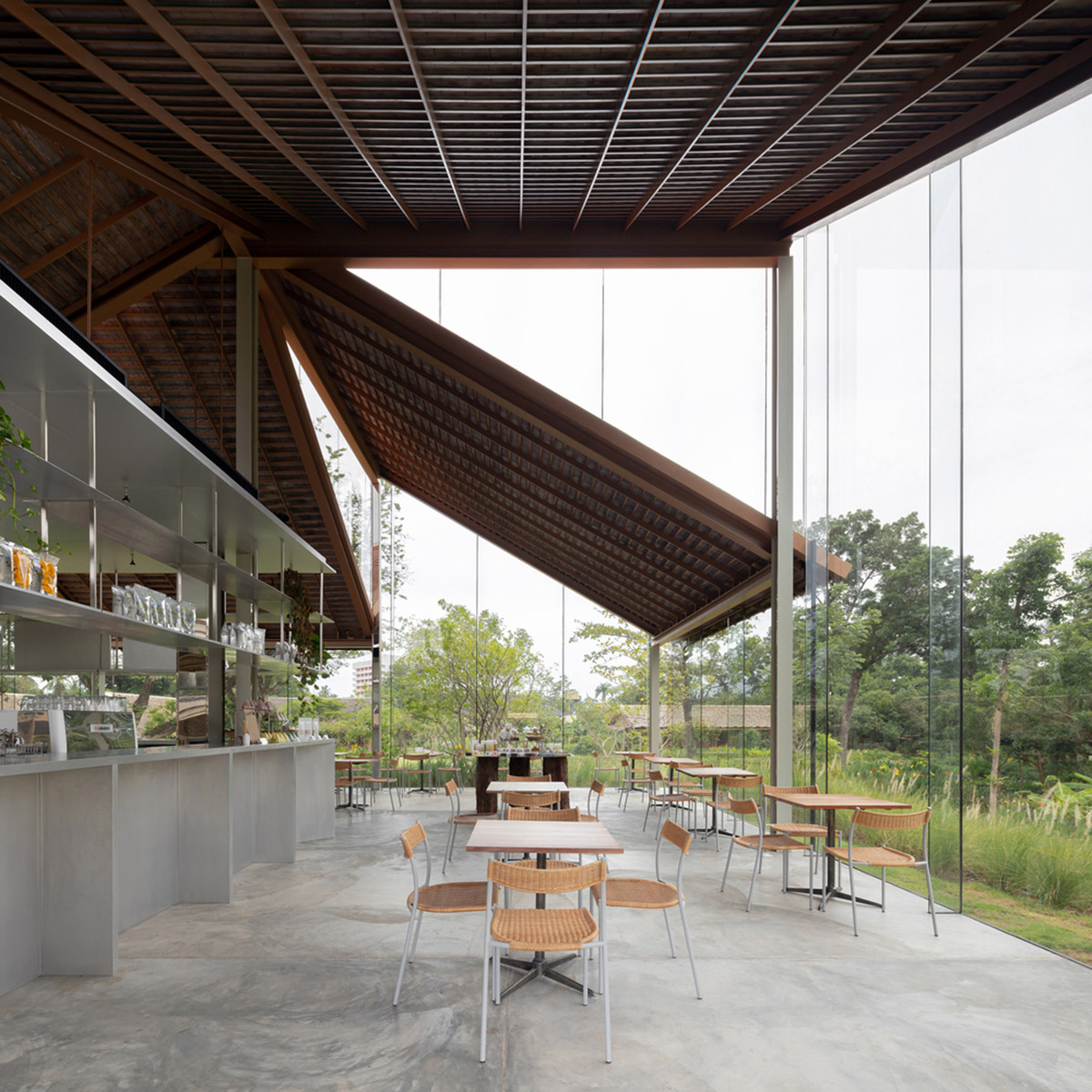 NITAPROW designed Patom Cafe with four segmented roof and thatched-roof walkway in Thailand