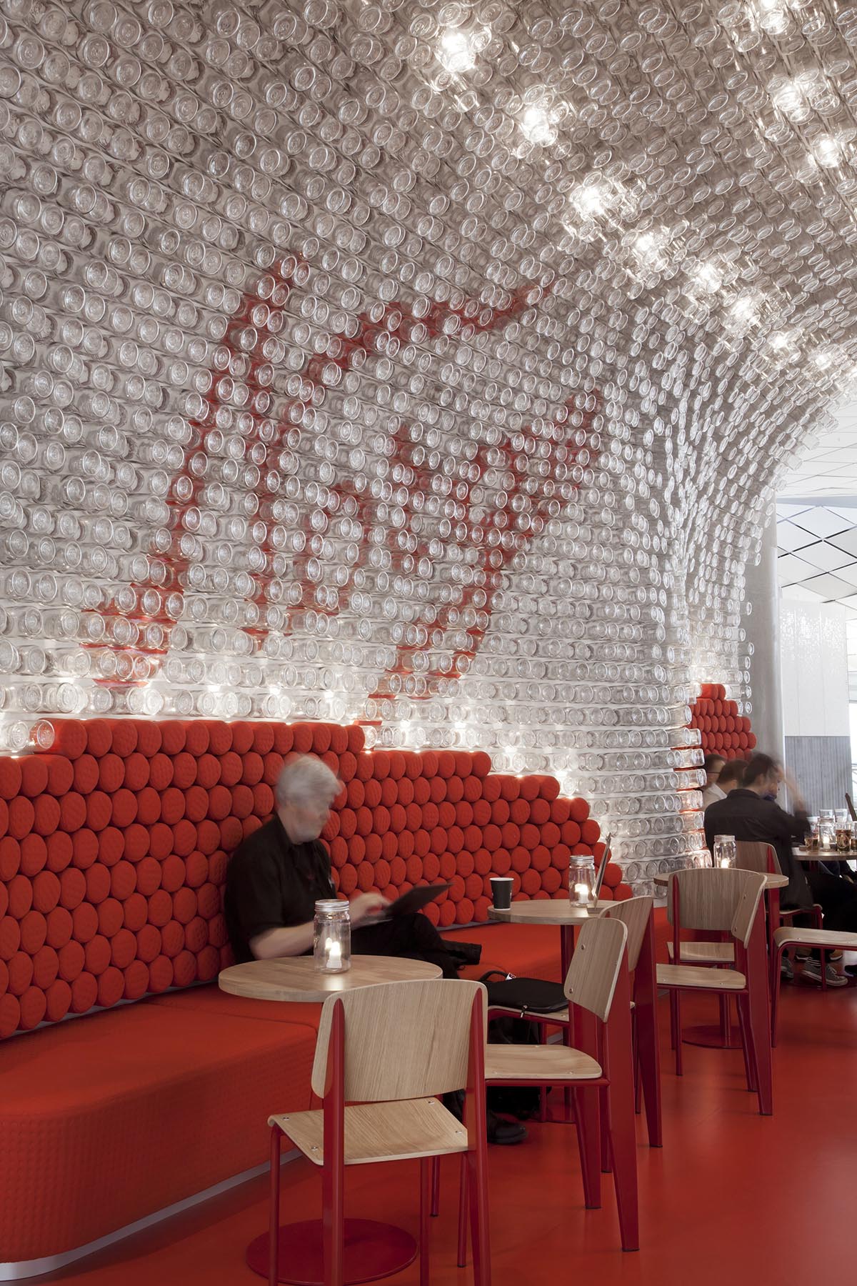 Snøhetta uses more than 4000 original Norgesglasset jars to create crystallized bar in Oslo’s airport
