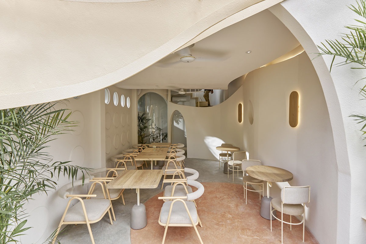 September Cafe is designed to look like a bird's nest with curved steel stripes in Vietnam