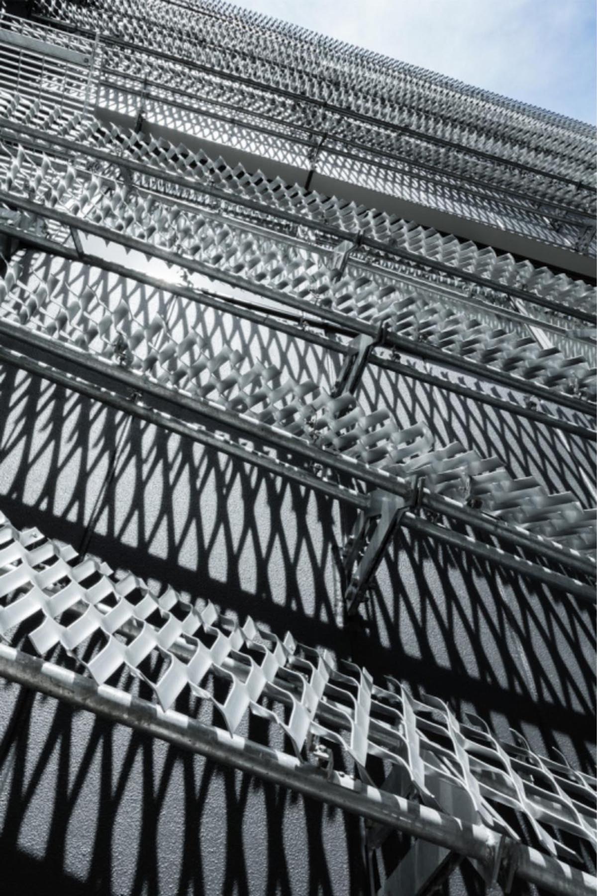 Kengo Kuma wraps alumni building in Tokyo with irregular metal surface creating organic skin