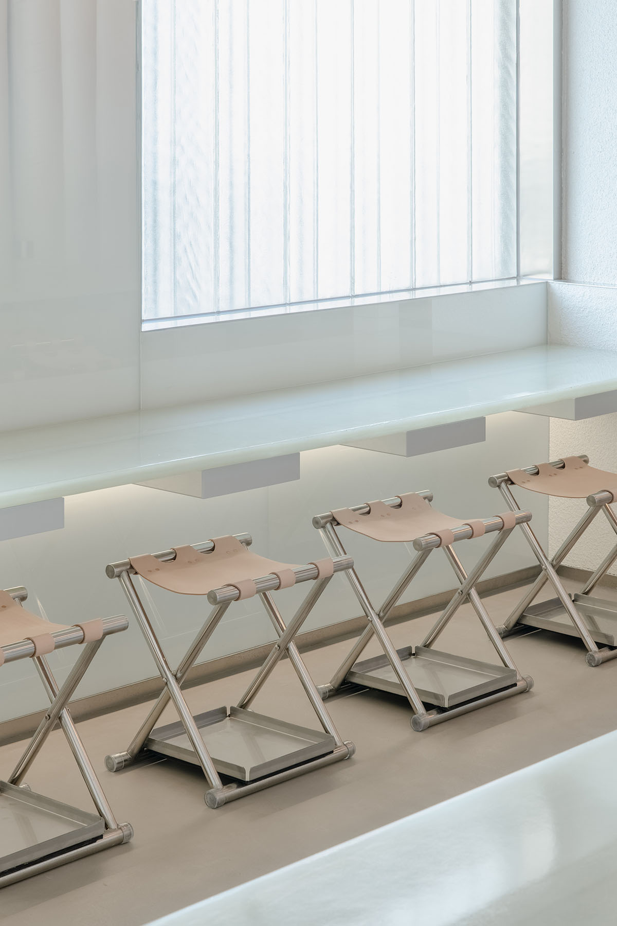 Office AIO creates foggy interiors for bar evoking facades of stacking high-rises with tiled columns