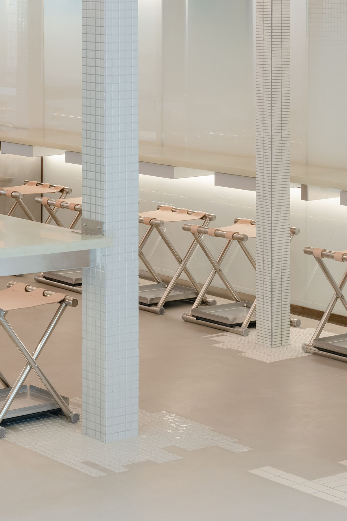 Office AIO creates foggy interiors for bar evoking facades of stacking high-rises with tiled columns