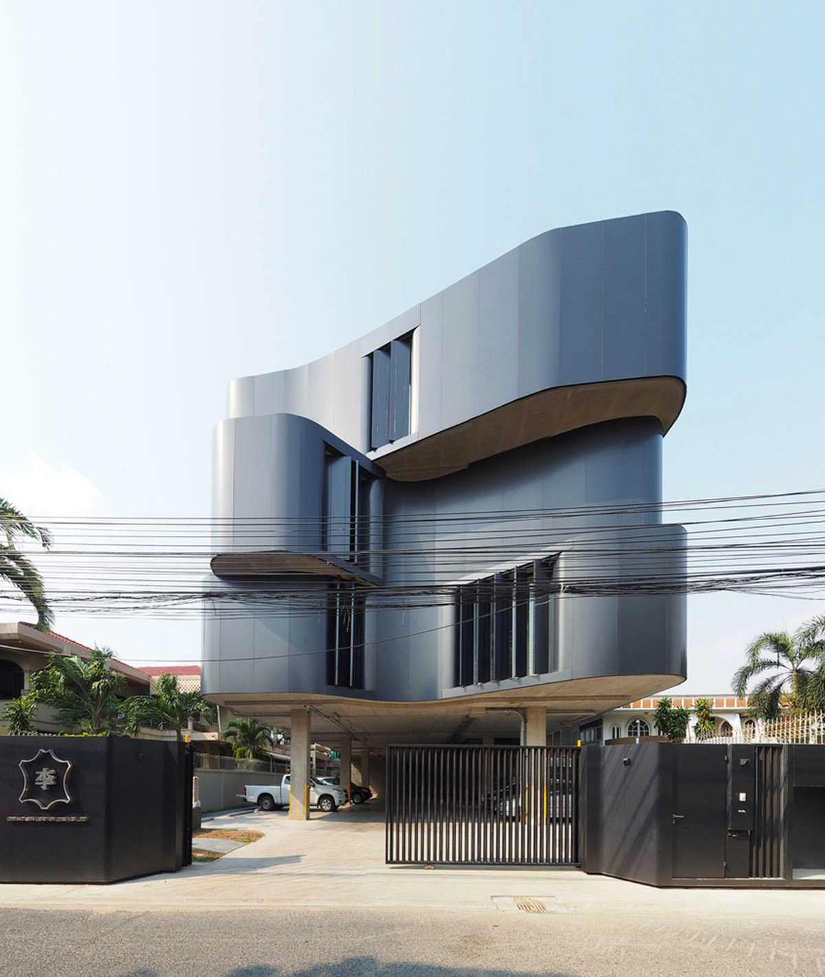 ASWA used physical character of leather to design this curved office building in Bangkok