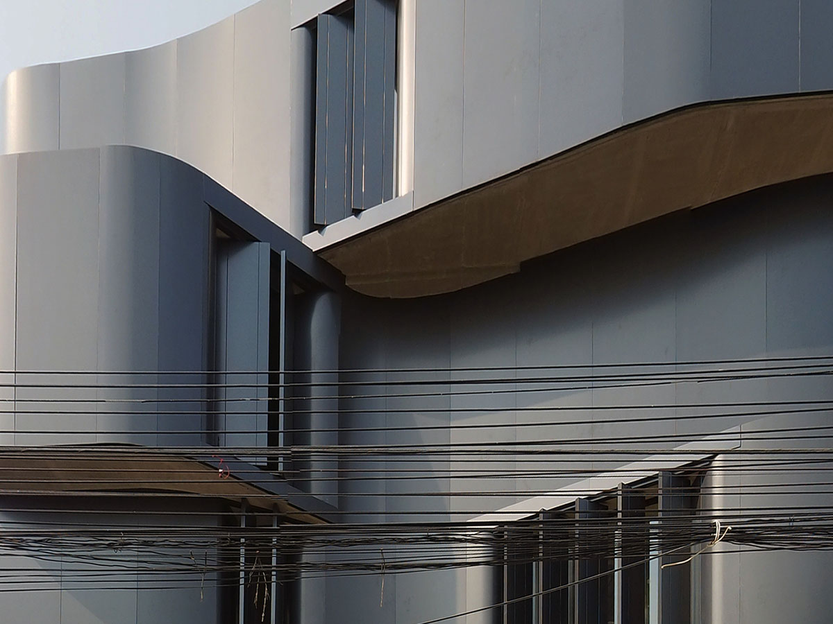 ASWA used physical character of leather to design this curved office building in Bangkok