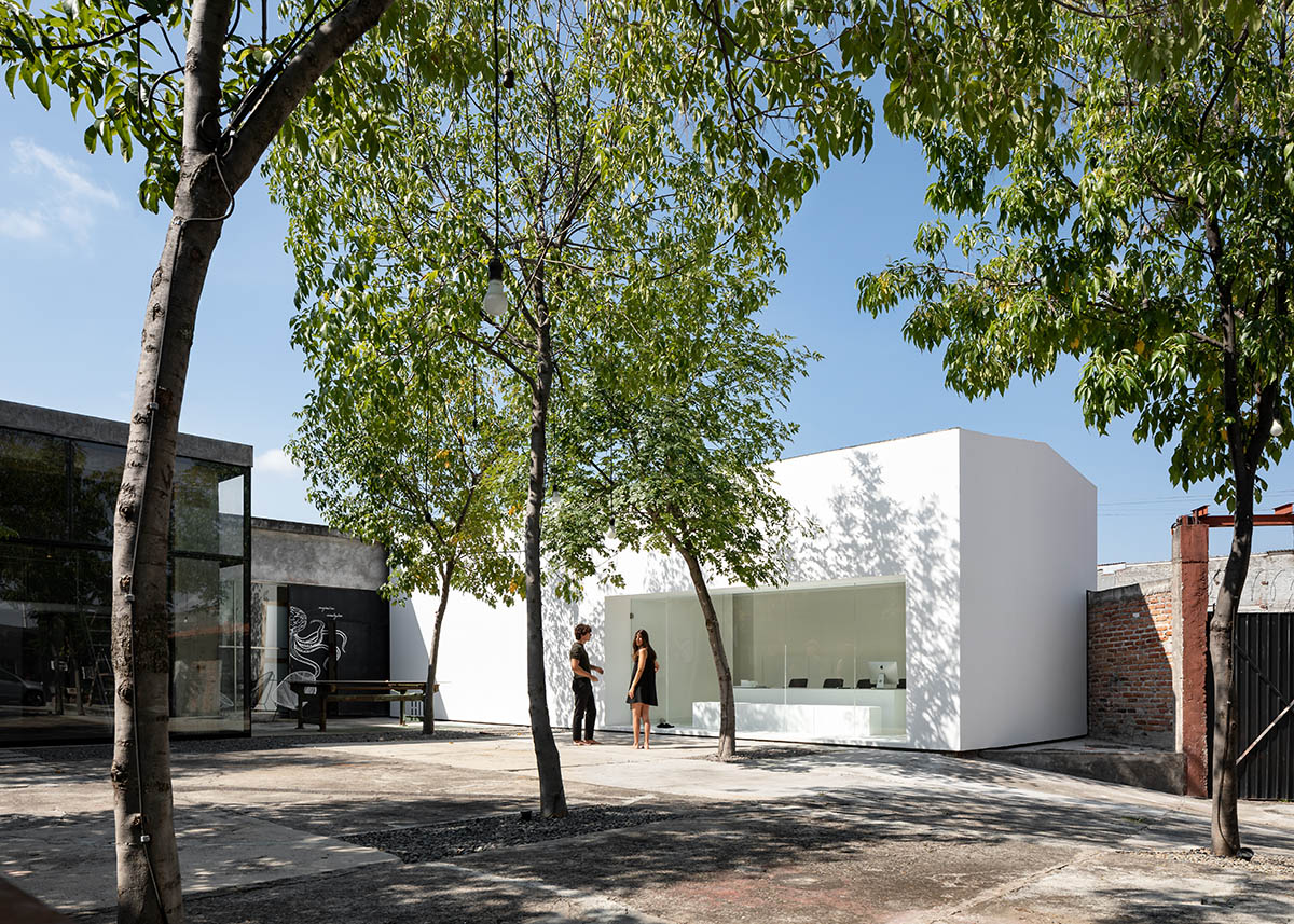 HW Studio Arquitectos converts old wood drying oven into its own studio with all-white colour volume