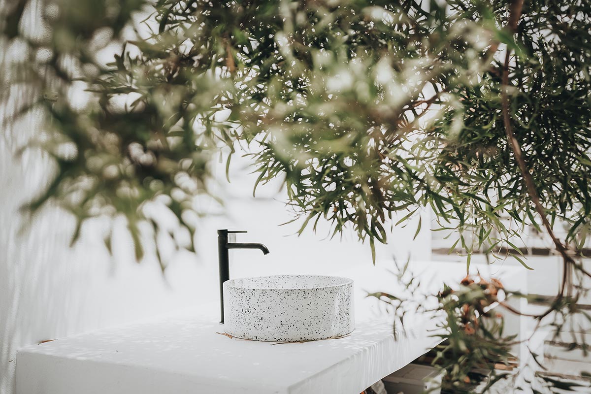 Lava-black landscape and palm trees inform this all-white house by OOOOX in Spain 