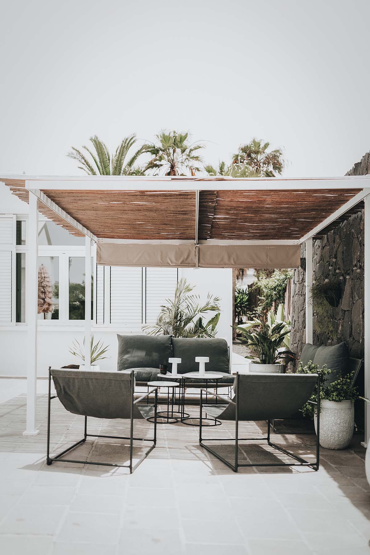 Lava-black landscape and palm trees inform this all-white house by OOOOX in Spain 