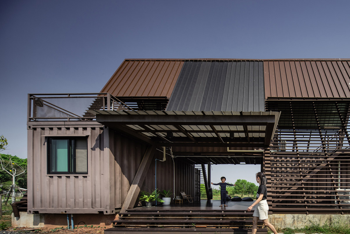 Disused shipping containers form a holiday home under A-frame roof by Tung Jai Ork Baab
