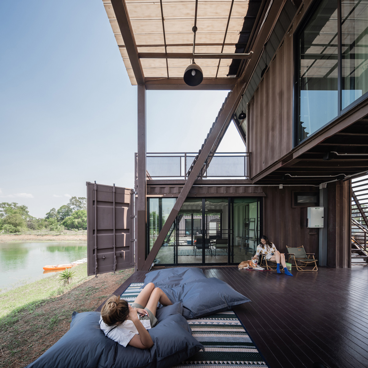 Disused shipping containers form a holiday home under A-frame roof by Tung Jai Ork Baab