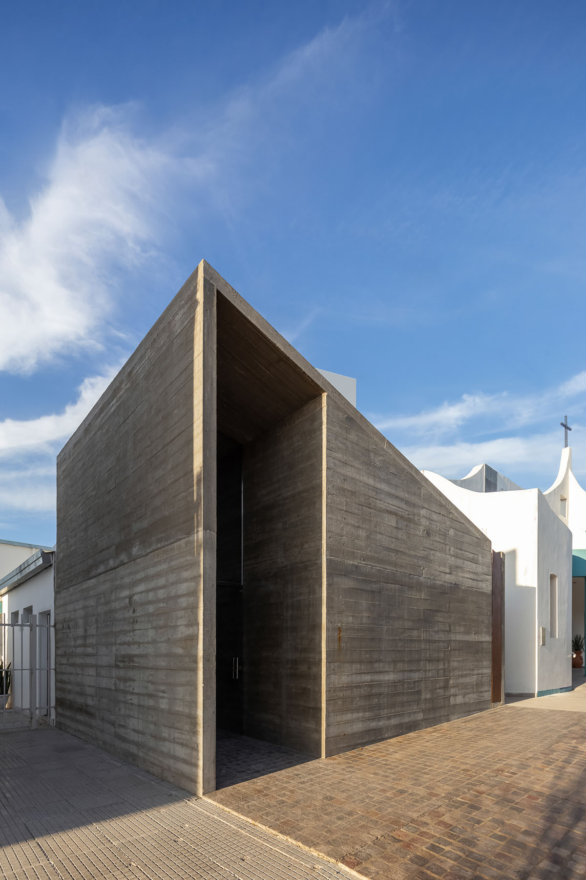 Asi Arquitectura completes small temple with gabled roof and side tower ...