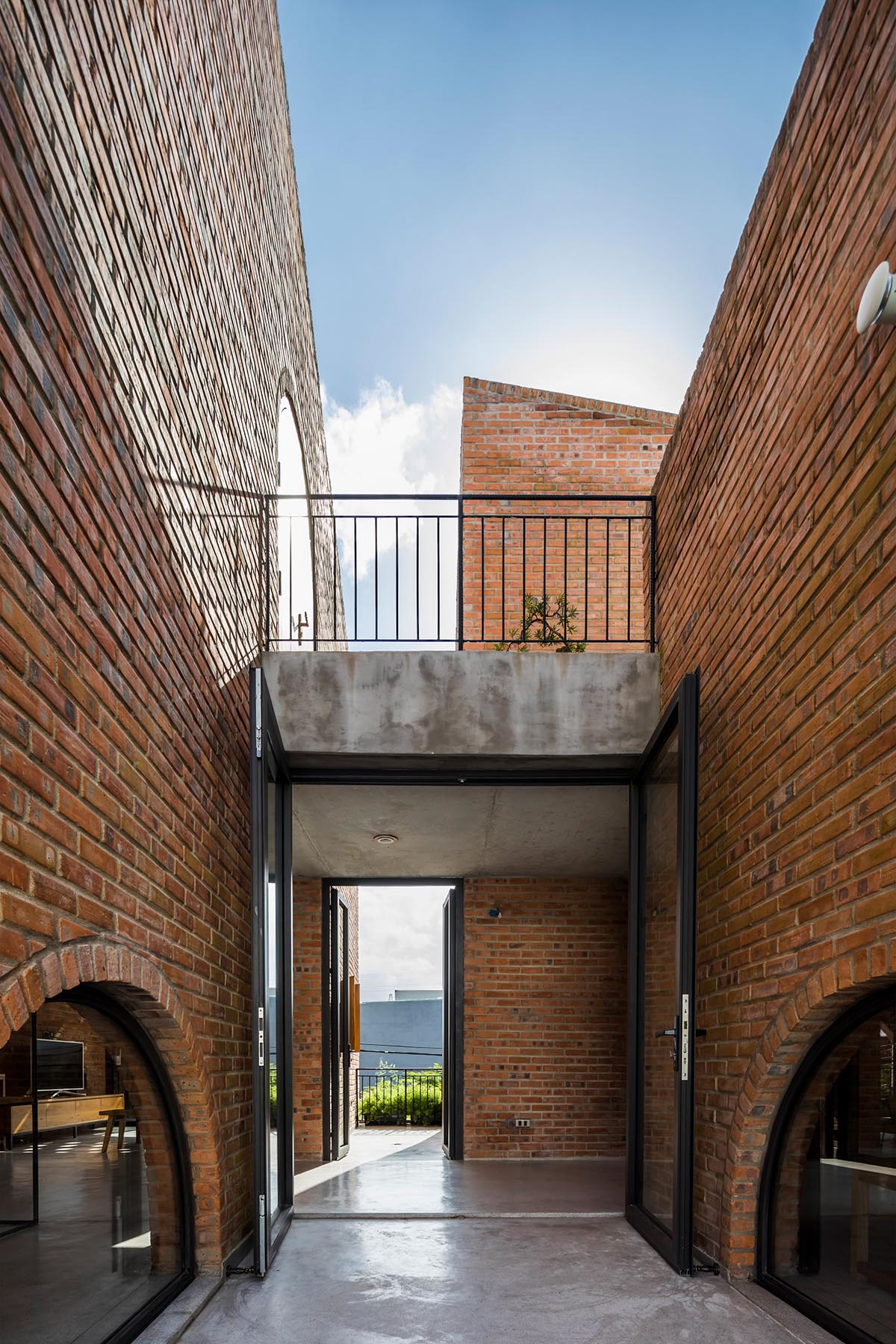 A coffee shop is combined with family house in an arched brick building ...