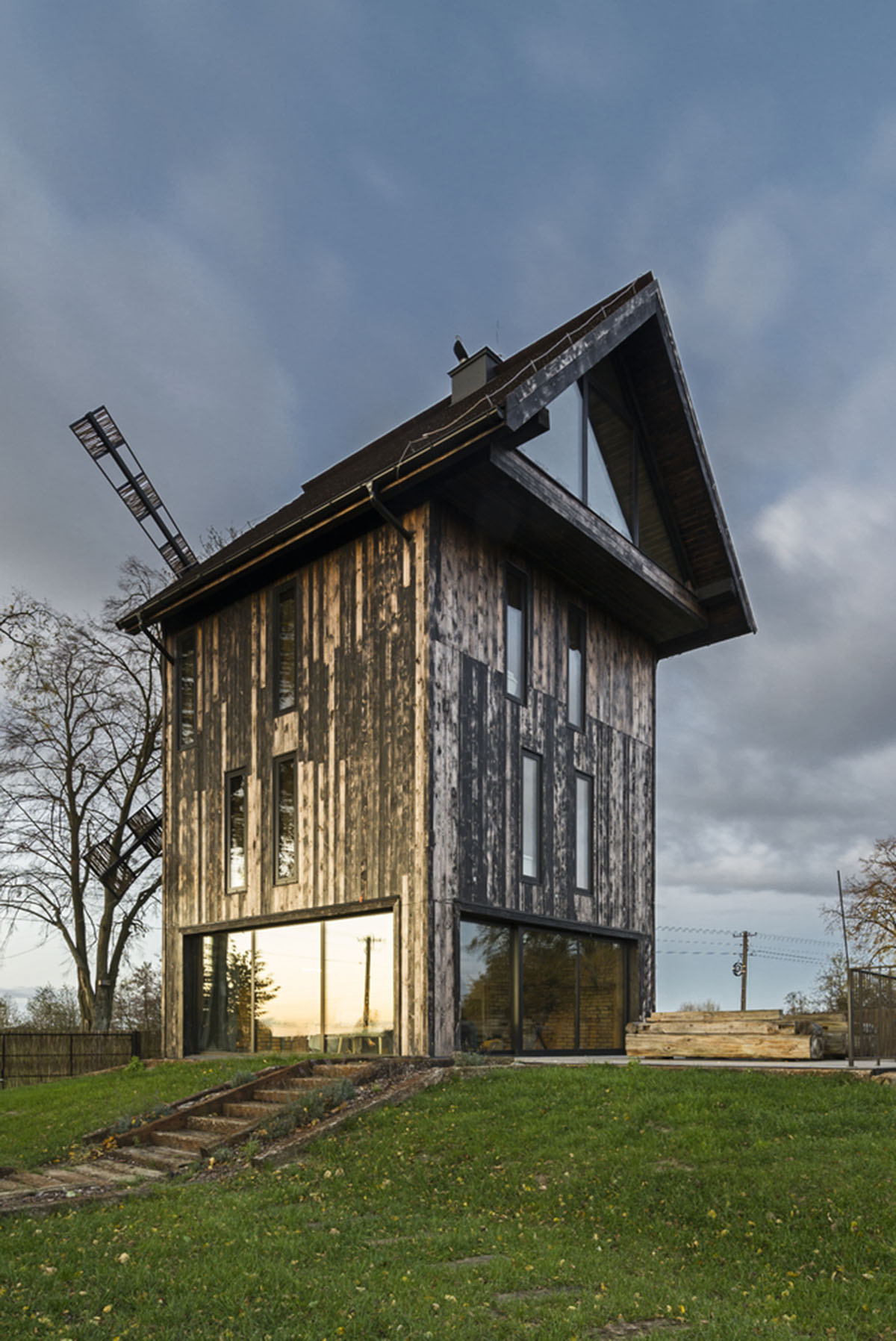 Michał Kucharski and o4 architekci clad old windmill with charred wood in a Polish town 