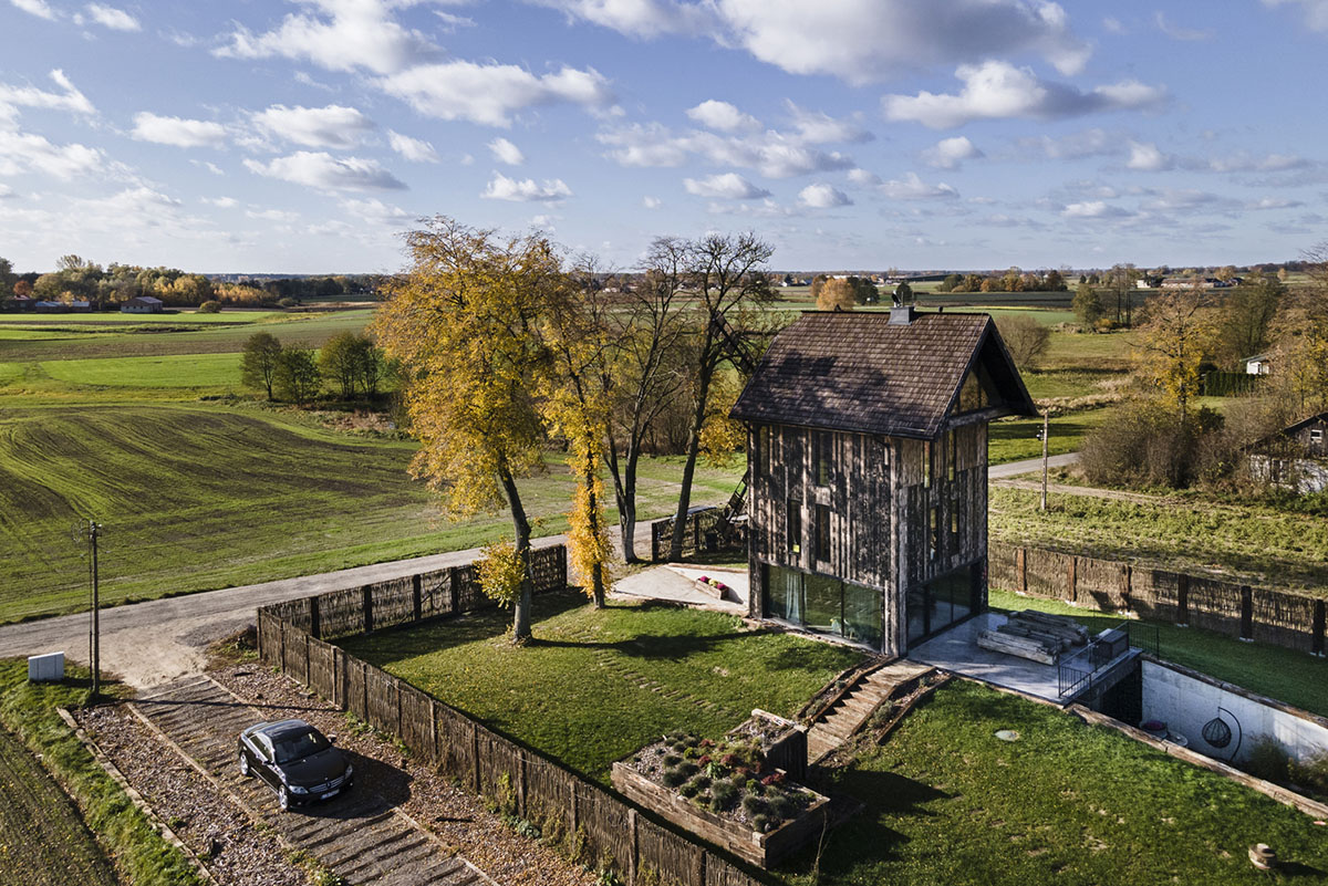 Michał Kucharski and o4 architekci clad old windmill with charred wood in a Polish town 