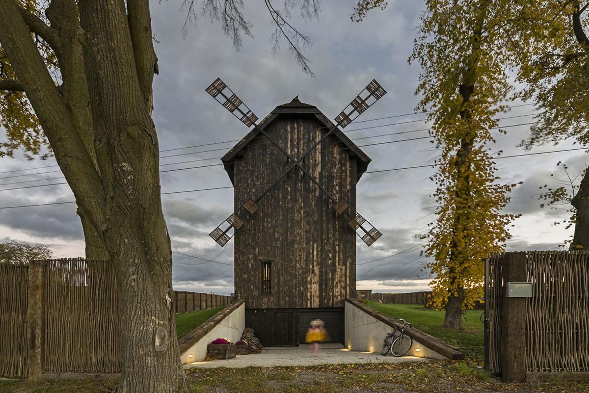 Michał Kucharski and o4 architekci clad old windmill with charred wood in a Polish town 