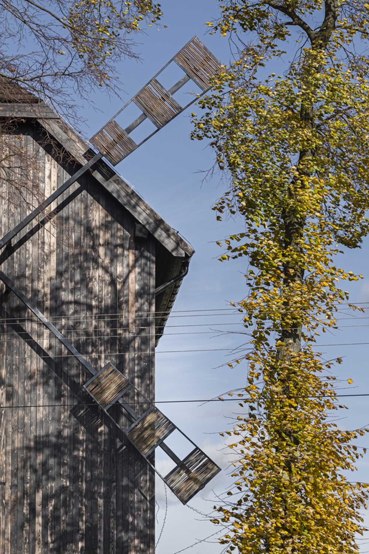 Michał Kucharski and o4 architekci clad old windmill with charred wood in a Polish town 