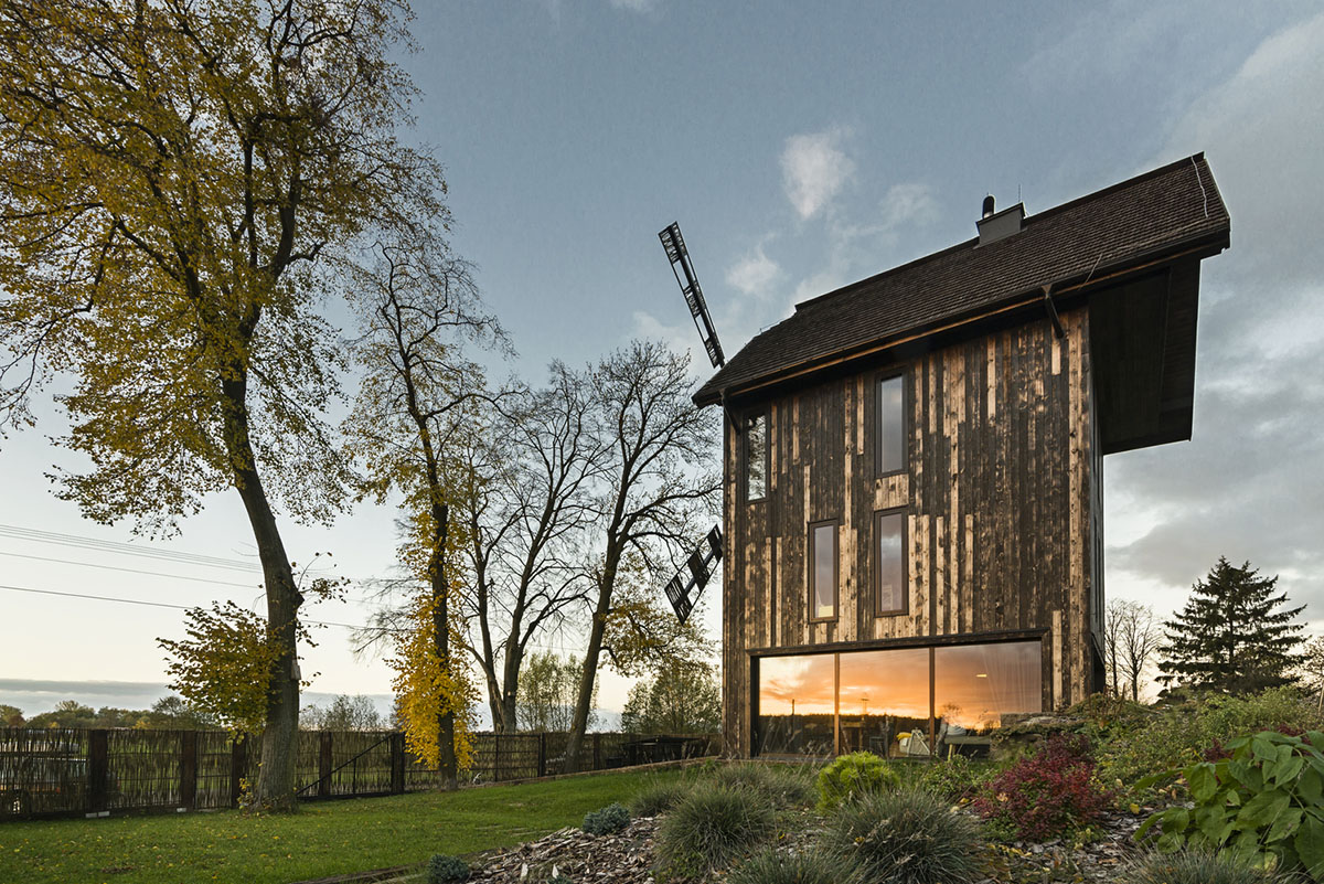 Michał Kucharski and o4 architekci clad old windmill with charred wood in a Polish town 