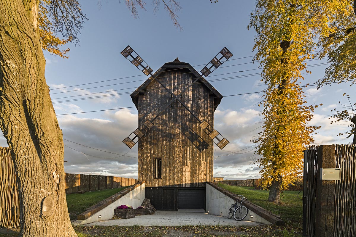 Michał Kucharski and o4 architekci clad old windmill with charred wood in a Polish town 