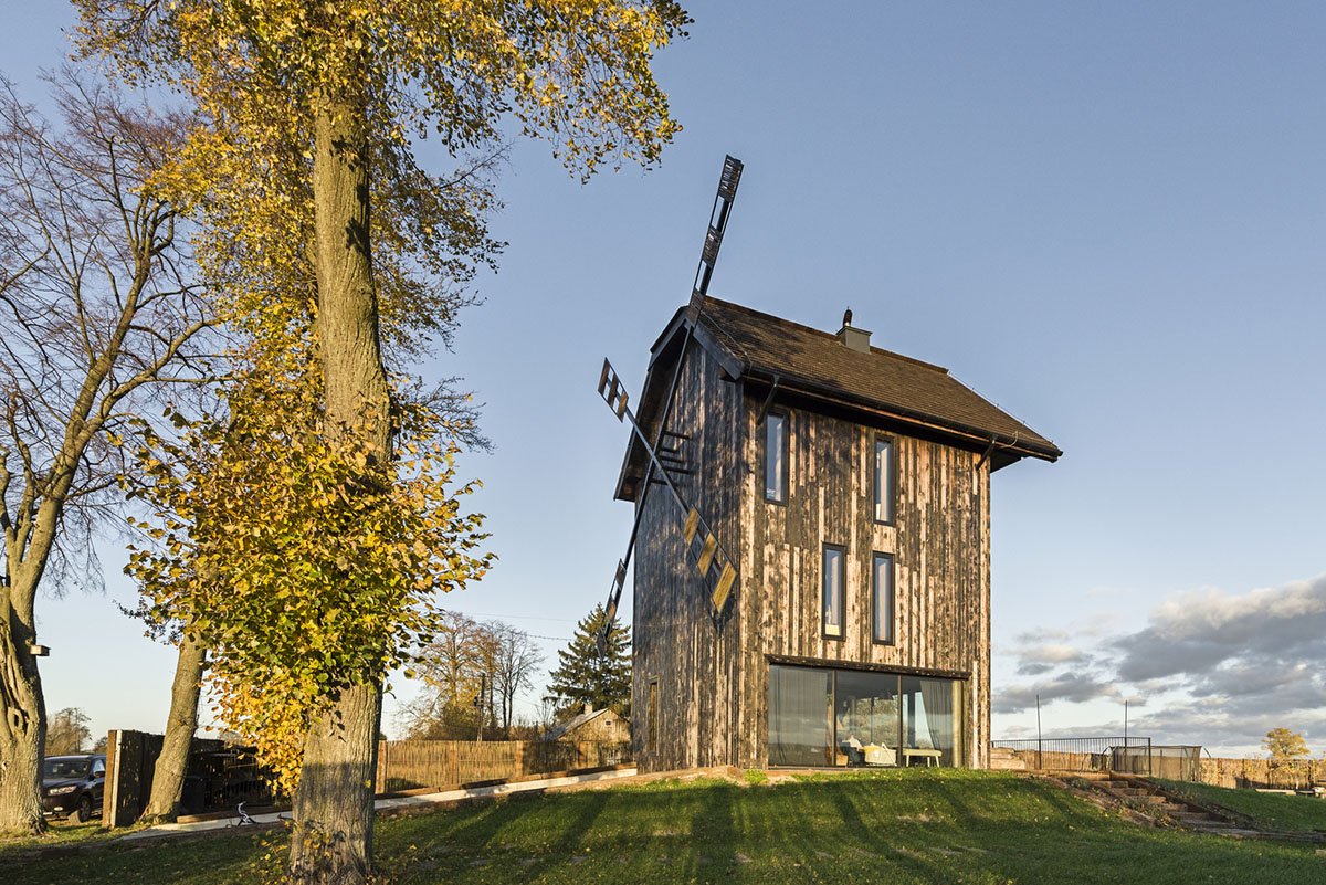 Michał Kucharski and o4 architekci clad old windmill with charred wood in a Polish town 