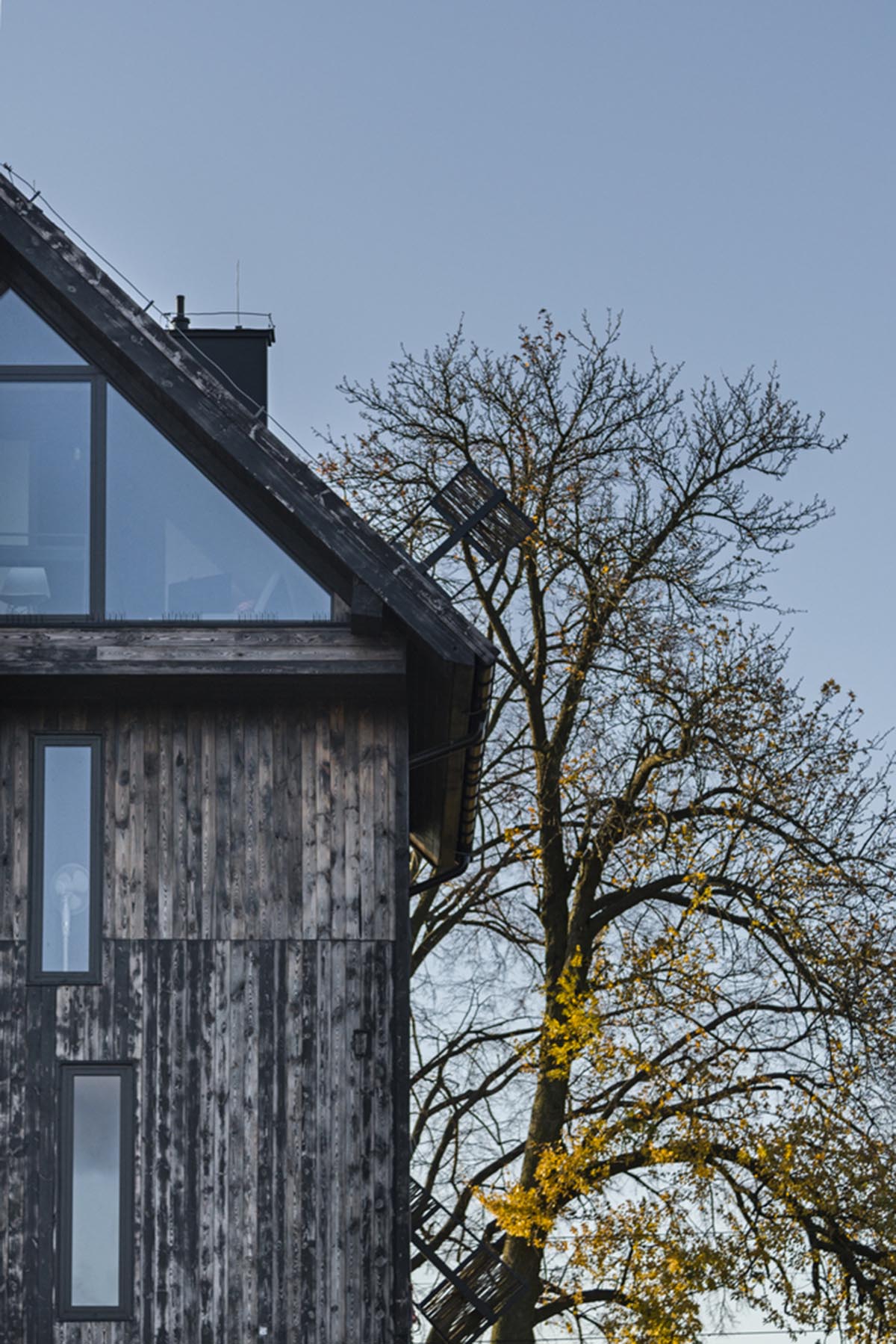 Michał Kucharski and o4 architekci clad old windmill with charred wood in a Polish town 