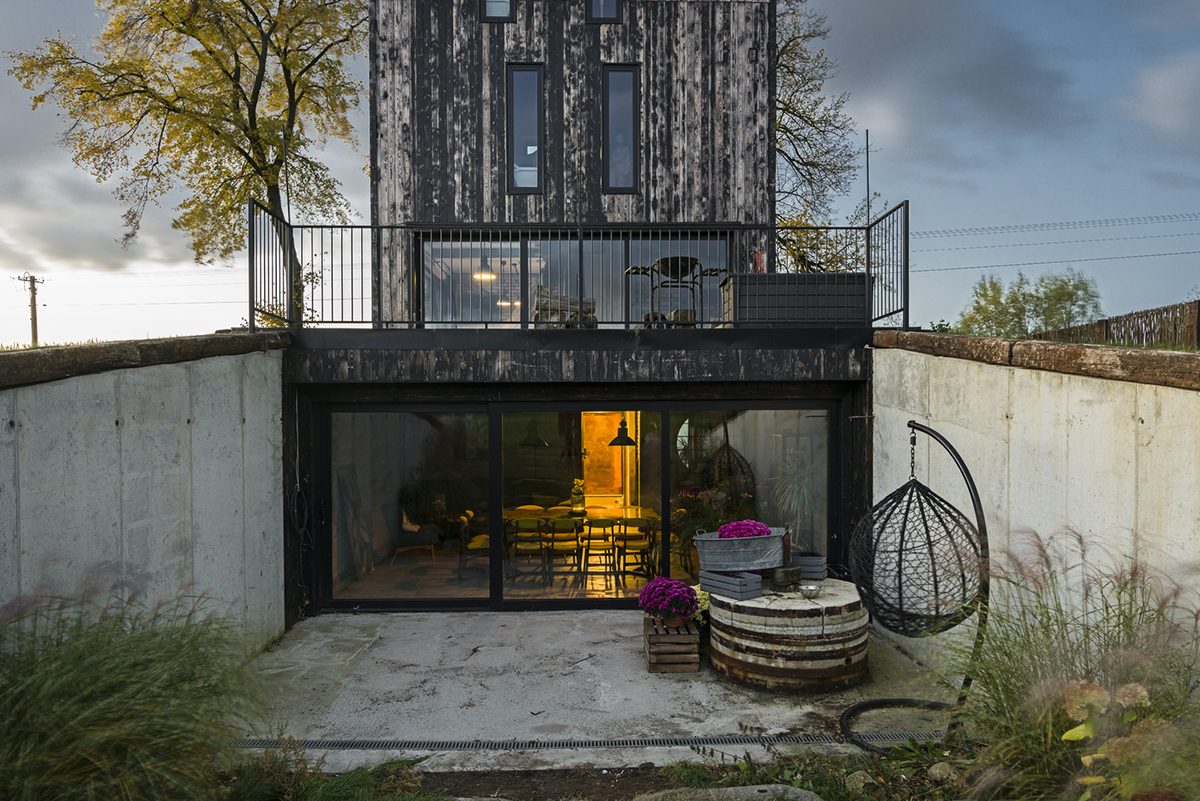 Michał Kucharski and o4 architekci clad old windmill with charred wood in a Polish town 
