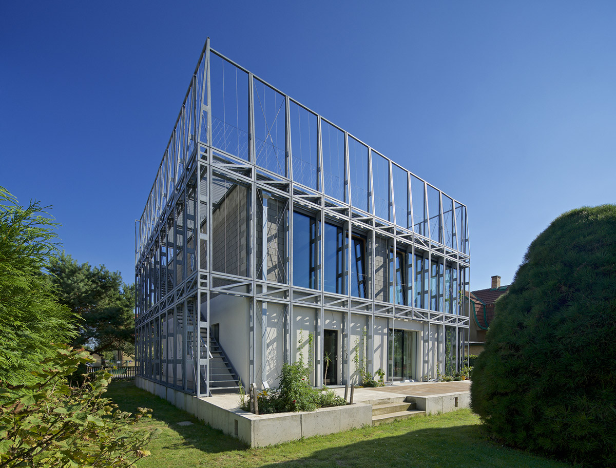 ŠÉPKA Architects wraps old residence with steel lattice featuring climbing plants as facade element