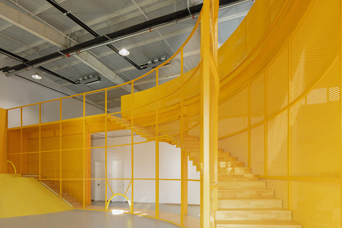 REDe Architects and Moguang Studio add red circular platform to renovated youth activity center