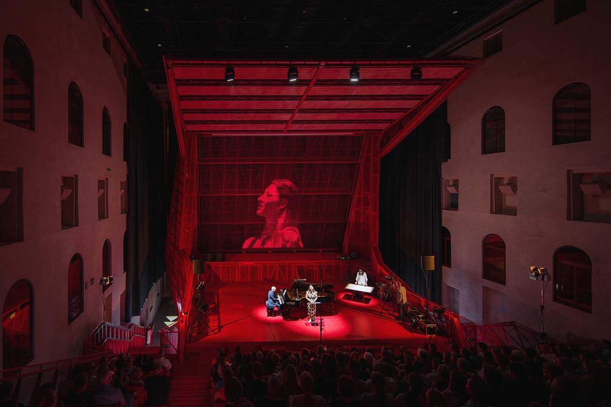 Bold red concert hall makes a statement as a harmonious blend of history and modern technology 