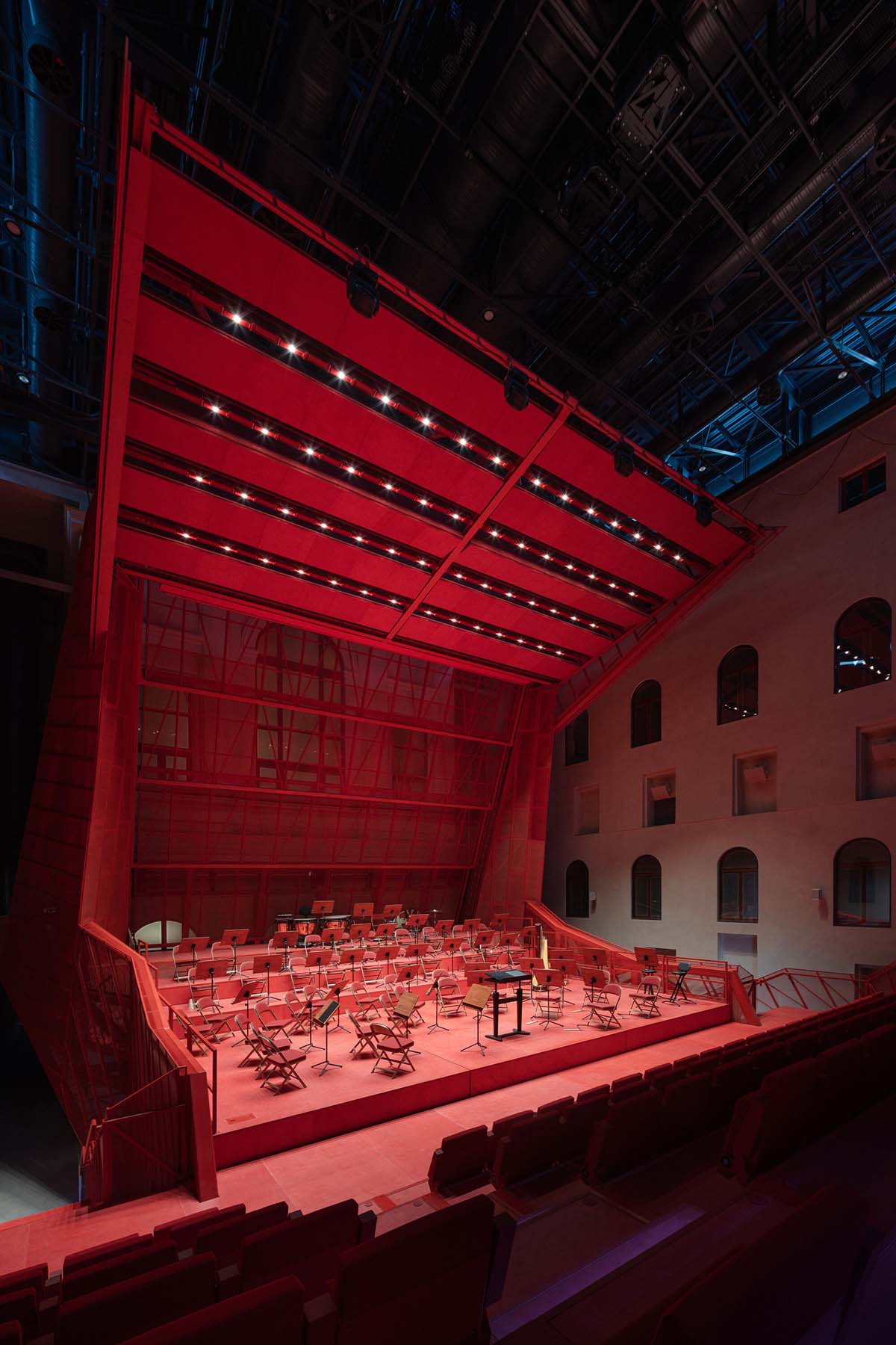Bold red concert hall makes a statement as a harmonious blend of history and modern technology 