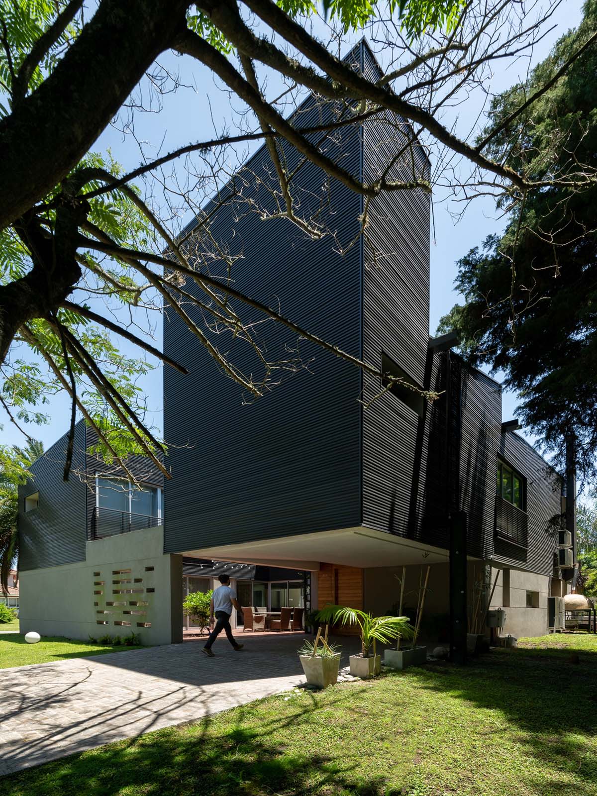 Además Arquitectura completes weekend house made from black corrugated metal sheets