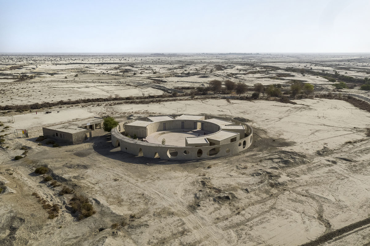 Circular wall featuring inhabitable holes encapsulates elementary school designed by Daaz Office