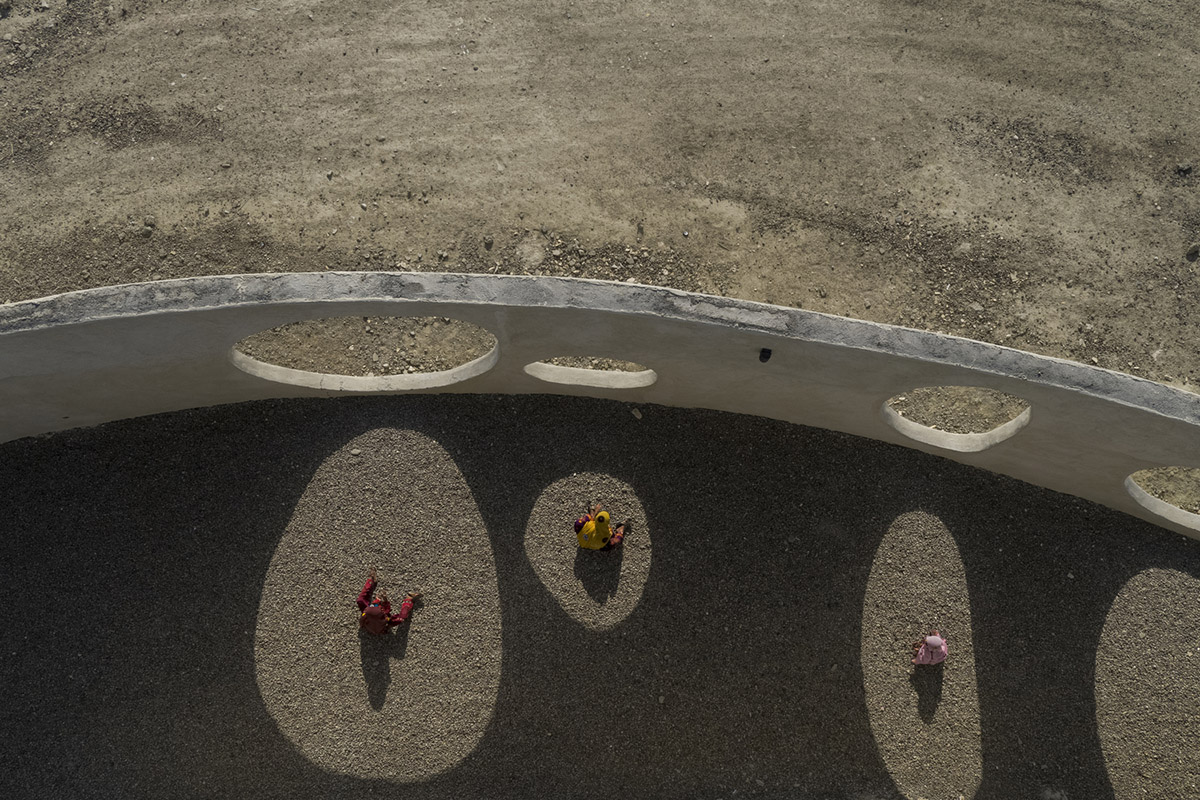 Circular wall featuring inhabitable holes encapsulates elementary school designed by Daaz Office
