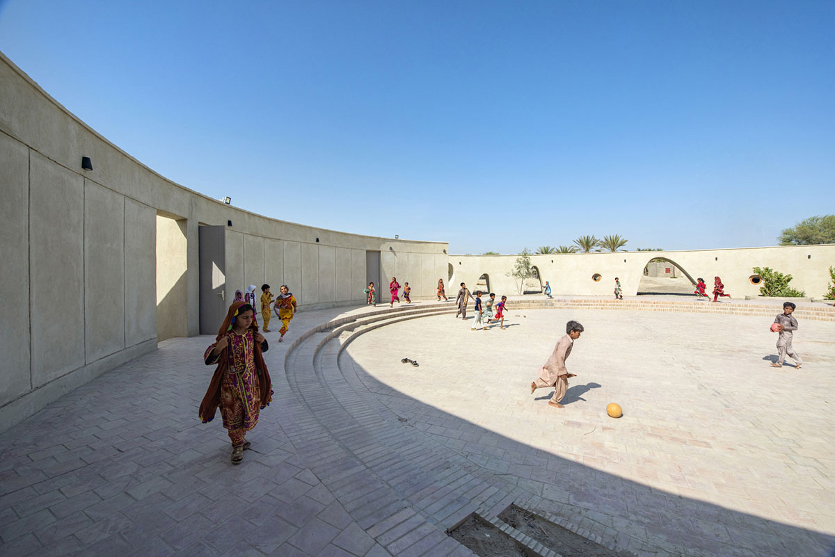 Circular wall featuring inhabitable holes encapsulates elementary school designed by Daaz Office