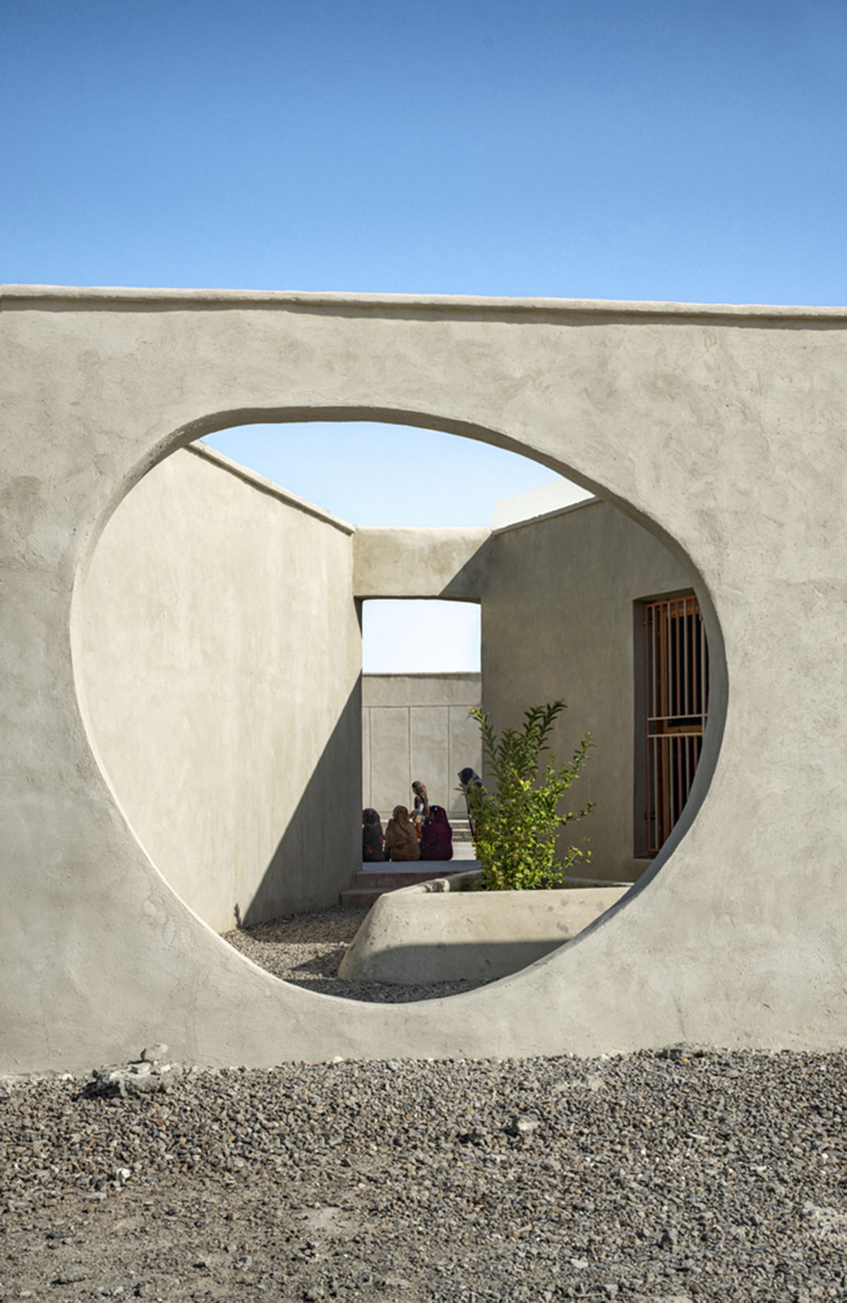 Circular wall featuring inhabitable holes encapsulates elementary school designed by Daaz Office