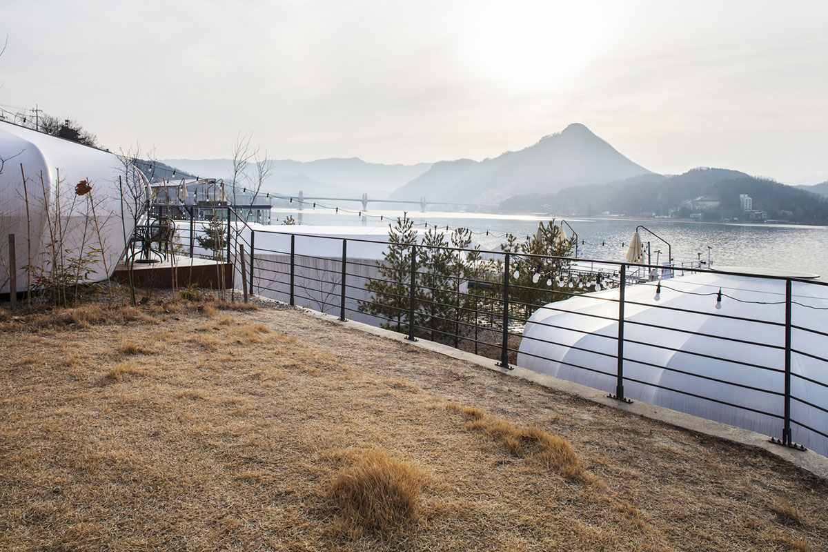 ArchiWorkshop combines oval guest rooms with museum in one landscape in South Korea