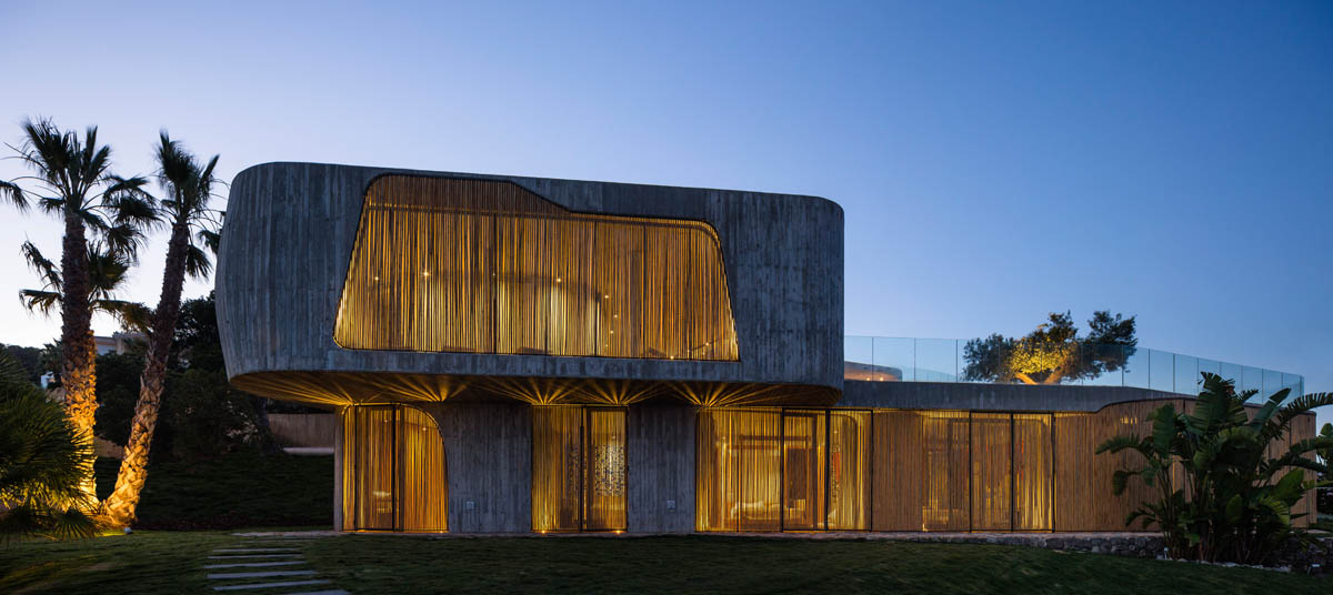 Villa Mediterraneo Ibiza adapts nature with organic form and bamboo shutters