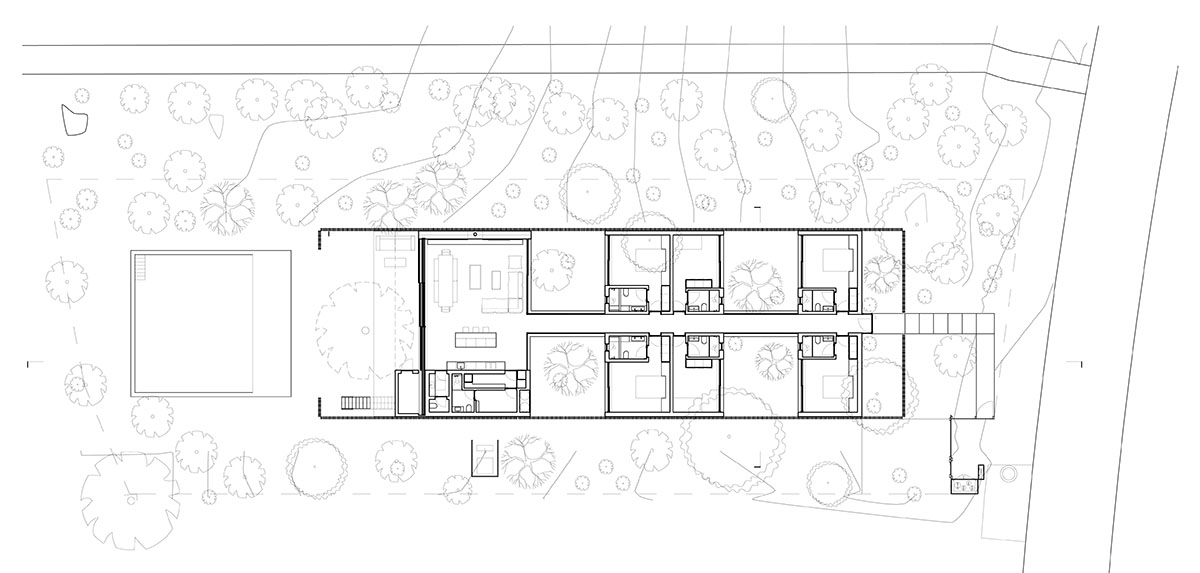 Palisade House is wrapped by a long palisade in fir wood to protect dunes in Troia, Portugal 