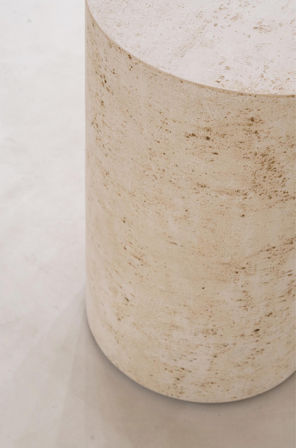 Tactile brick complements beige hues and mirrored surfaces for the interior of cosmetic showroom