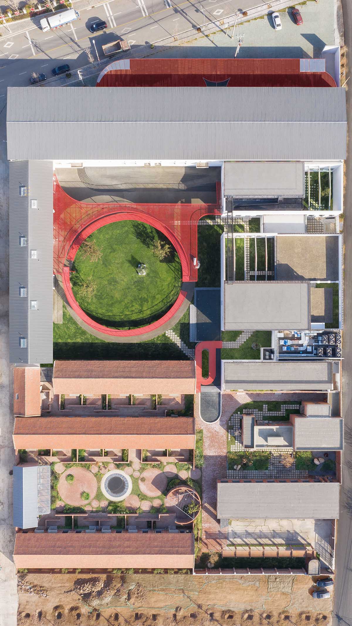 REDe Architects and Moguang Studio add red circular platform to renovated youth activity center