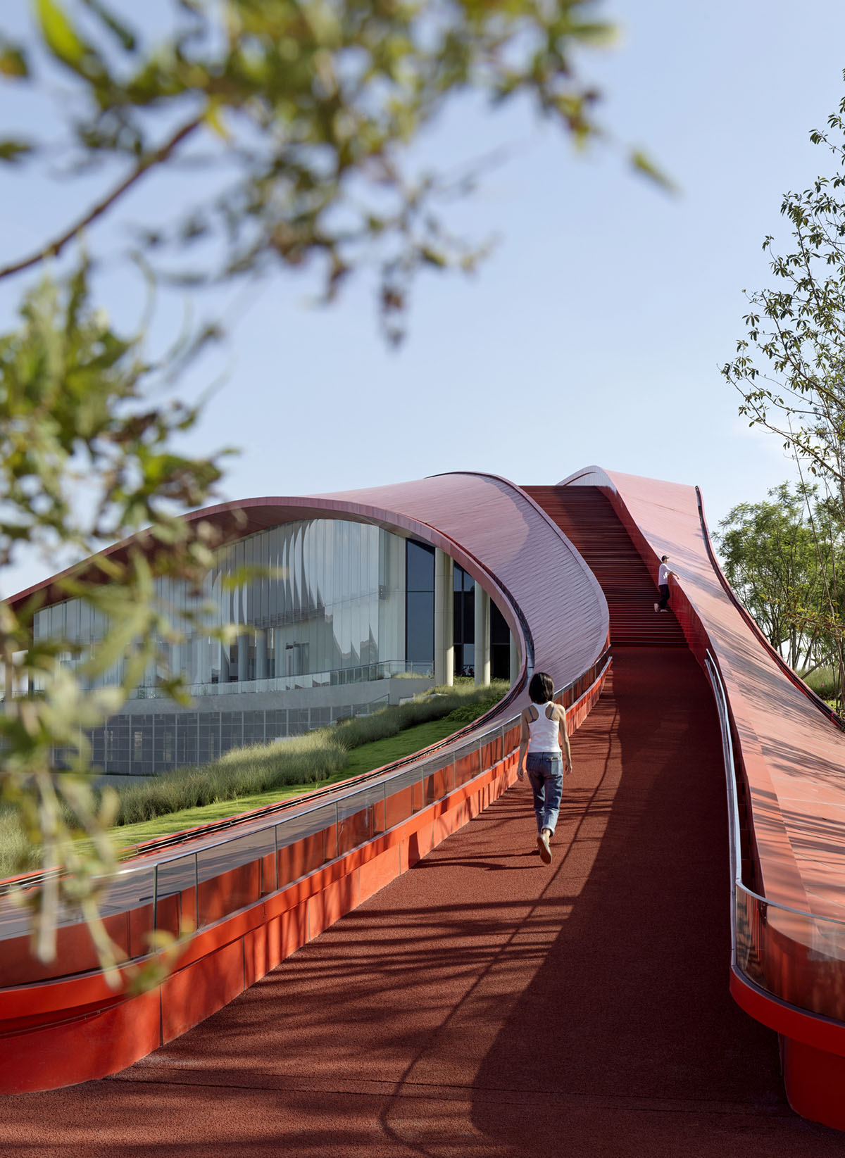 Sinuous red roof combines technology museum and reception center in Chengdu by Powerhouse Company
