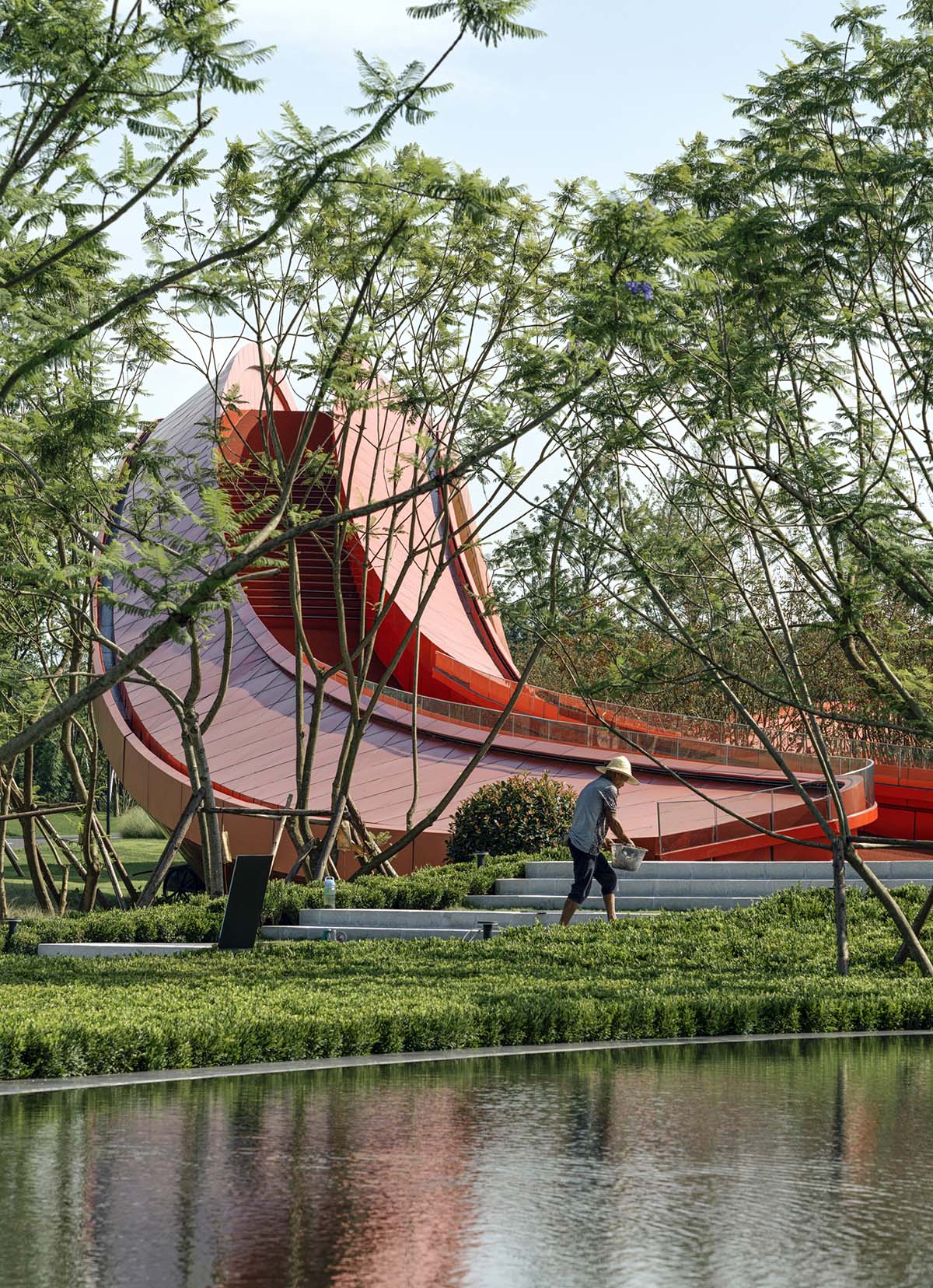 Sinuous red roof combines technology museum and reception center in Chengdu by Powerhouse Company