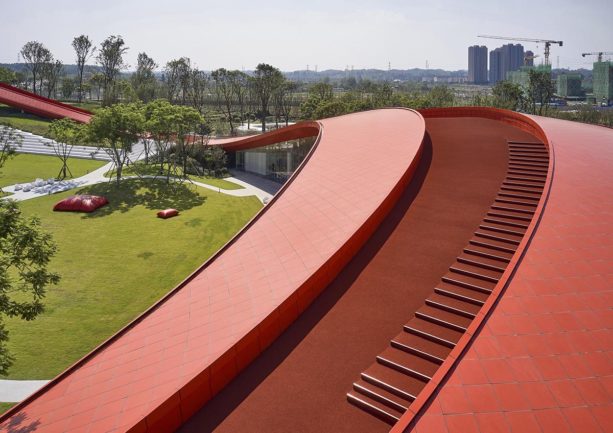 Sinuous red roof combines technology museum and reception center in Chengdu by Powerhouse Company