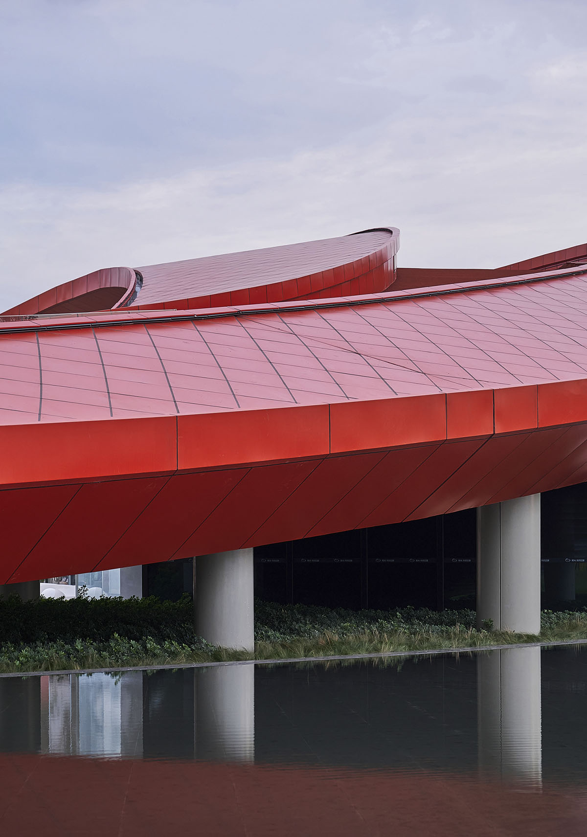Sinuous red roof combines technology museum and reception center in Chengdu by Powerhouse Company