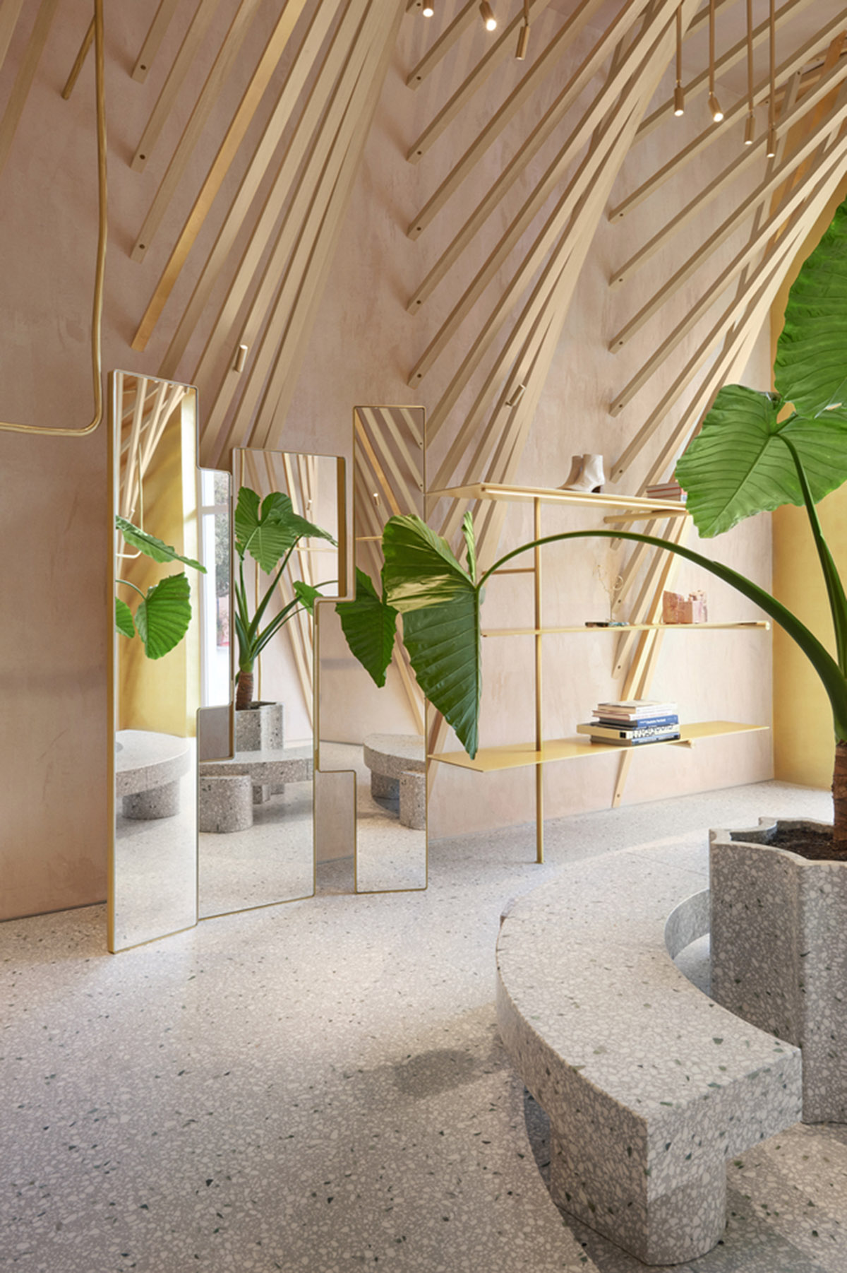 Golden and powder-colored details dominate forte_forte forte dei Marmi boutique in Italy