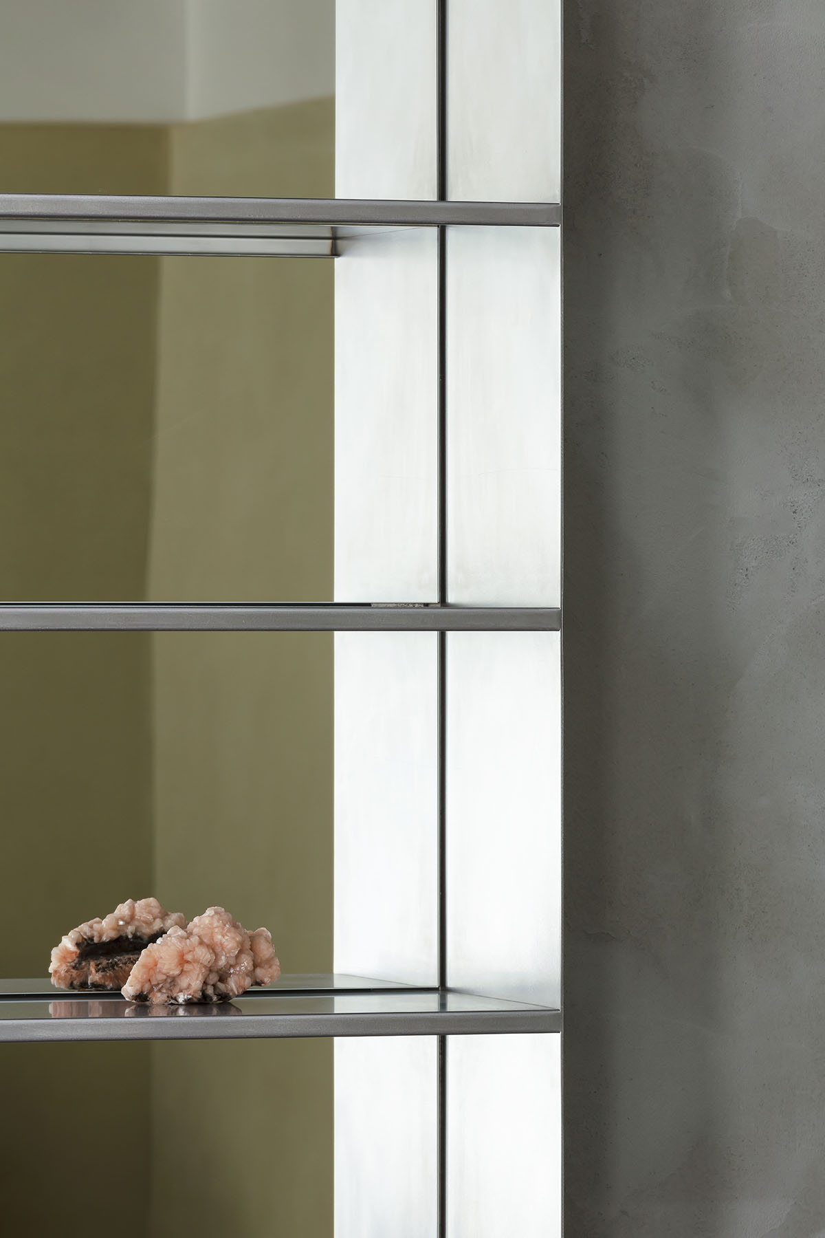 Light green, grey tones and mirrored surfaces dominate interiors of an apartment by Atelier Dialect