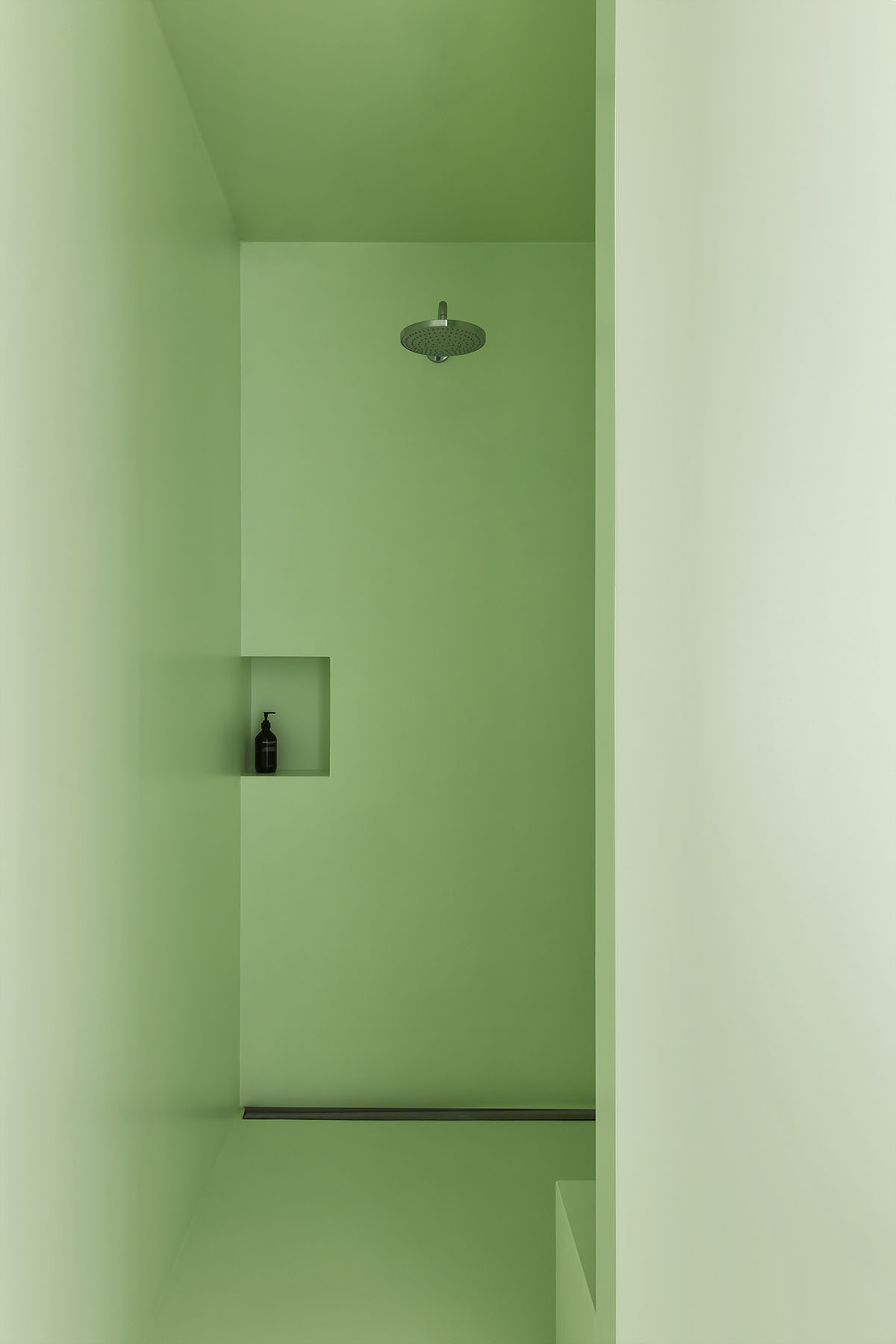 Light green, grey tones and mirrored surfaces dominate interiors of an apartment by Atelier Dialect