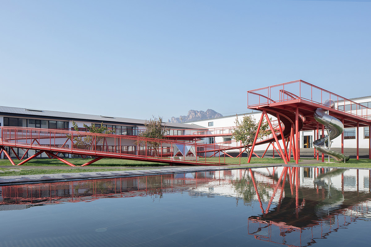 REDe Architects and Moguang Studio add red circular platform to renovated youth activity center