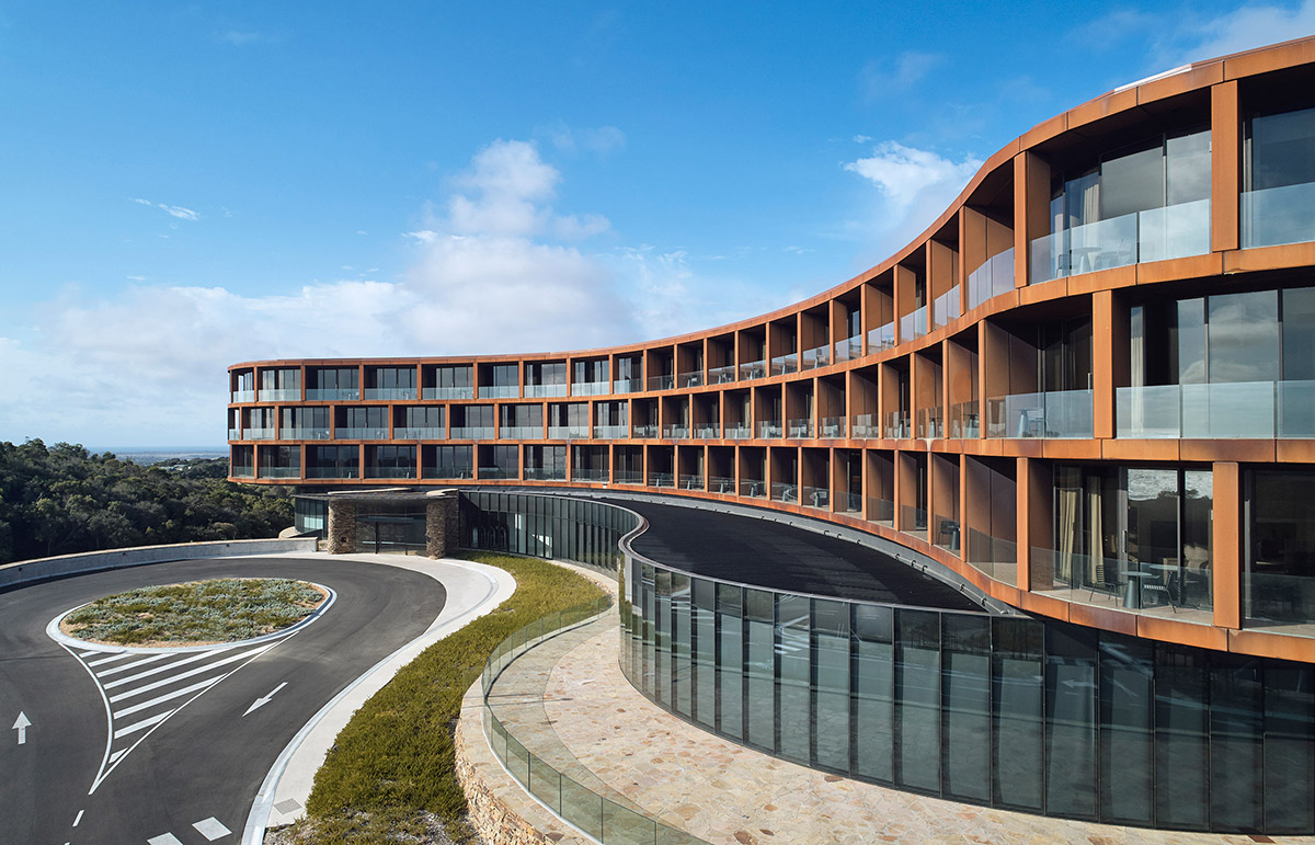 Wood Marsh completes sinuous resort anchored on hand-built locally sourced stone plinth in Australia