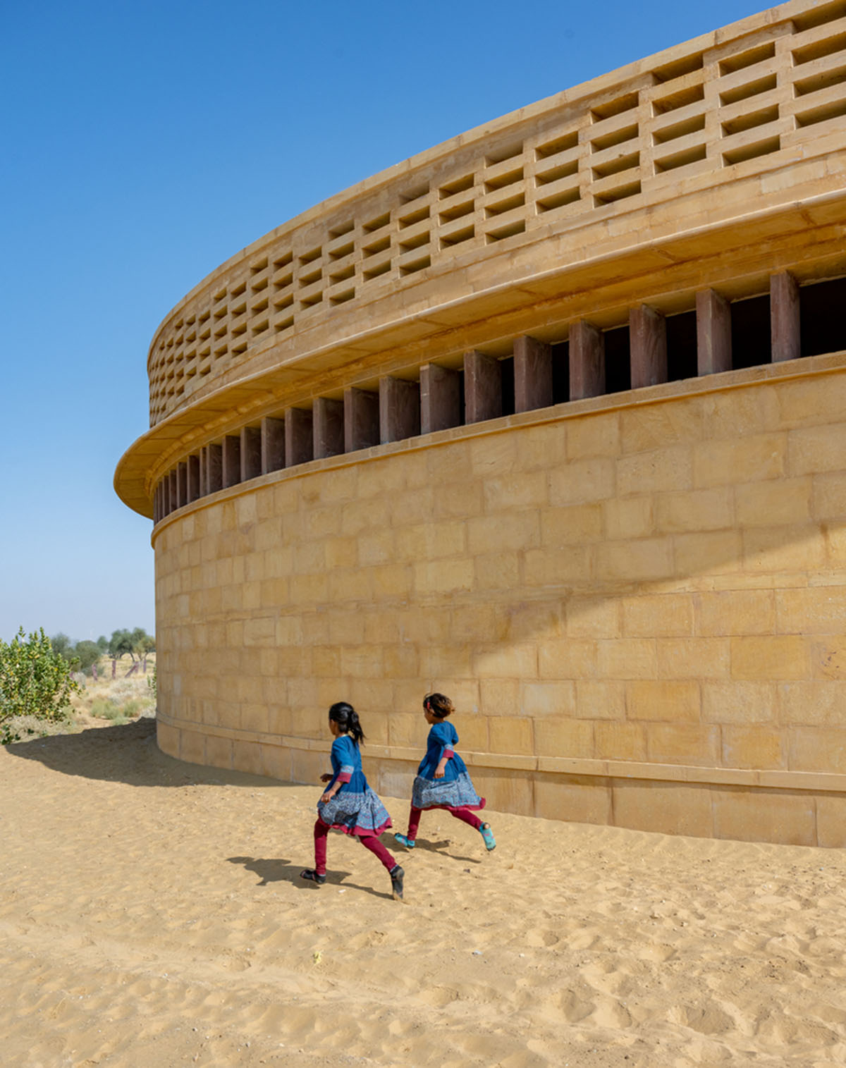 Diana Kellogg Architects' oval-shaped girl's school is made of hand-carved sandstone in rural India