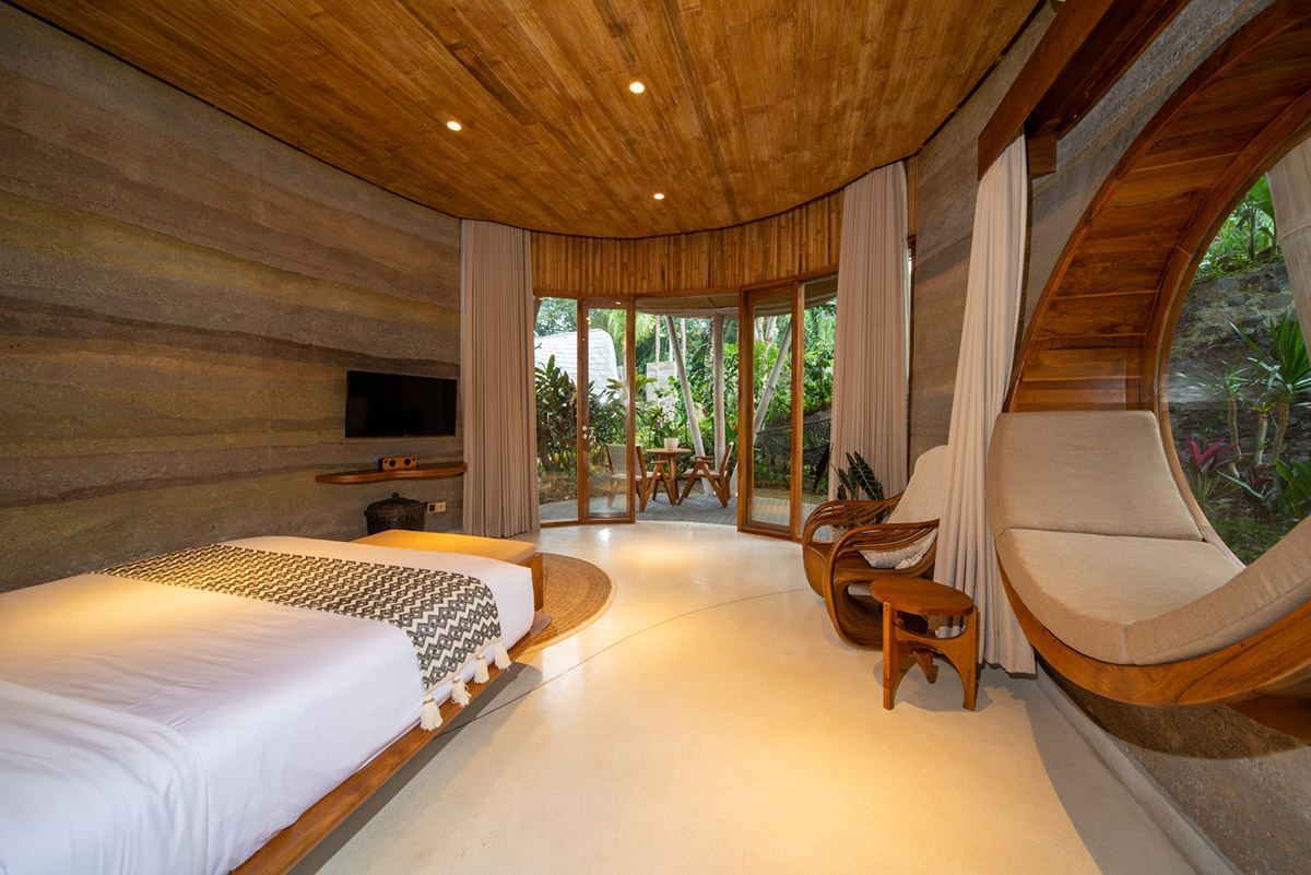 Undulating bamboo roofs wrap this wellness retreat in a lush forest of Bali